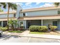 Two-story townhouse boasting tropical landscaping and a screened entry at 40 Moree Loop # 11, Winter Springs, FL 32708