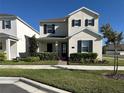 Inviting two-story home boasting fresh green grass and simple shrubbery for enhanced curb appeal at 5059 Lake Hamlin Trl, Winter Garden, FL 34787