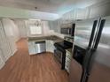 Well-lit kitchen featuring modern appliances and light gray cabinets, and an open view to the dining area at 5417 Lake Margaret Dr # 39, Orlando, FL 32812