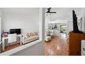Open-concept condo featuring hardwood floors, neutral paint, modern furniture and a seamless flow into the kitchen at 5417 Lake Margaret Dr # 39, Orlando, FL 32812
