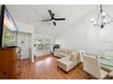 Bright living room featuring a vaulted ceiling, hardwood floors and a dining area, creating a cozy and inviting space at 5417 Lake Margaret Dr # 39, Orlando, FL 32812