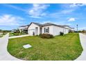 Well manicured lawn surrounding single Gathering home with a two-car garage, and inviting curb appeal at 5733 Iron Brand Rd, St Cloud, FL 34771