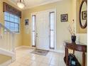 Bright foyer featuring neutral paint, tile flooring, and decorative details at 7407 Excitement Dr, Reunion, FL 34747