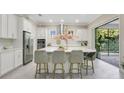 Bright kitchen with stainless steel appliances, a large island, white cabinets, and an elegant tile backsplash at 9888 Mere Pkwy, Orlando, FL 32832