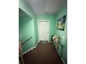 Hallway in condo featuring a unit number, interior stairway, and decorative accents at 1010 Loch Vail # 1125, Apopka, FL 32712