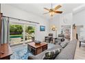 Bright living room with slider door and view of backyard pool area at 12712 Forestedge Cir, Orlando, FL 32828