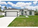 Close-up view of a new construction with a white exterior, a black roof and black trim around the door and windows at 16121 Sw 37Th Terrace Rd, Ocala, FL 34473