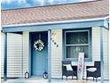 Inviting front porch with seating and decorative wreath, creating a welcoming entrance at 1795 Orange View Ct, Kissimmee, FL 34746
