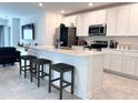 Beautiful kitchen with white cabinets, stainless steel appliances, and a center island at 1902 Presley Pl, Kissimmee, FL 34746