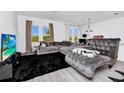 Bright living room with large sectional, chaise lounge, accent rug, and neutral paint at 2126 Derwent Dr, Davenport, FL 33896