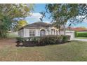 Beautiful single-story home showcasing manicured landscaping and architectural columns at 250 Lakeridge Ct, Winter Springs, FL 32708
