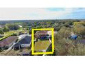 Aerial view of the backyard showing the lawn and patio with a partial view of the area at 25012 Chipshot Ct, Sorrento, FL 32776