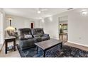 Cozy living room featuring a plush sofa, area rug, and ample natural light at 31024 Prestwick Ave, Sorrento, FL 32776