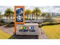 Beautifully landscaped Storey Lake community entrance with stone signage, mature palms, and manicured lawns at 3121 Paradox Cir # 307, Kissimmee, FL 34746
