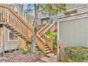 Exterior view of a building with a wooden staircase surrounded by landscaping, offering easy access at 336 Scottsdale Sq # 336, Winter Park, FL 32792
