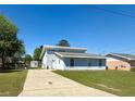 Two-story home featuring a driveway and lush green lawn at 38 Juniper Pass Dr, Ocala, FL 34480
