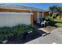 Exterior of a one-story home with a walkway and potted plants at 46 Silver Park Cir, Kissimmee, FL 34743