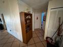 Hallway with tile flooring, decorated walls, and doors leading to other rooms at 46 Silver Park Cir, Kissimmee, FL 34743