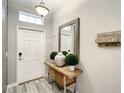 Inviting entryway featuring tiled floors, a decorative table, and welcome decor at 4704 Sleepy Hollow Dr, Kissimmee, FL 34746