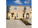Charming townhome with an ample driveway and well-maintained landscaping for a welcoming curb appeal at 4707 Coral Castle Dr, Kissimmee, FL 34746