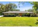 Charming single story home with a well-maintained lawn and rock accents at 5370 Whispering Pine Cir, St Cloud, FL 34771