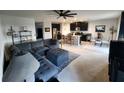 Open-concept living room, island kitchen with granite countertops, and comfortable living space at 5526 Bonn Way, St Cloud, FL 34771