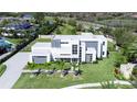 Stunning aerial view of modern property with a geometric design, lush landscaping, and a sleek, fenced perimeter at 6106 Marleon Dr, Windermere, FL 34786