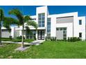 Modern two-story home with geometric design and large windows overlooking manicured landscaping, enhancing curb appeal at 6106 Marleon Dr, Windermere, FL 34786