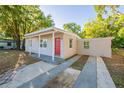 Inviting single-story home showcasing a red front door, covered porch, and freshly painted exterior at 616 Conroy St, Orlando, FL 32805