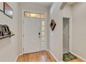 Bright foyer with wood floors and a modern white door with glass panes, offering a welcoming entrance at 6799 Helmsley Cir, Windermere, FL 34786