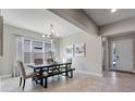 Bright dining room featuring tile floors, modern light fixture, and a contemporary dining table with bench seating at 7131 Desert Mandarin St, Winter Garden, FL 34787