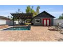 Backyard featuring a pool, cabana, and brick patio, perfect for outdoor entertaining at 833 N Thornton Ave, Orlando, FL 32803