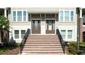 Brick stairs and well-kept landscaping leading to inviting townhome entrances with neutral exteriors at 869 Taramundi Dr, Oviedo, FL 32765