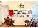 View of kitchen featuring a breakfast bar, appliances, and natural light at 115 Orchid Dr, Davenport, FL 33897