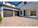 Spacious brick driveway leading to a two-car garage, covered entryway, and front door at 14645 Scott Key Dr, Winter Garden, FL 34787