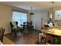 Cozy dining area featuring wood floors, a decorative light fixture, and lots of natural light at 1486 Randolph St, Deltona, FL 32725