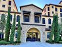 Attractive stone accented building entrance showcasing an arched entryway and well maintained landscaping at 16300 County Road 455 # 513, Montverde, FL 34756