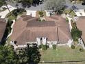 Aerial view of the townhome and landscaping with an asphalt shingle roof at 1886 Saint Andrews Pl # 1886, Longwood, FL 32779