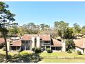 Aerial view of the back of the townhome featuring a second story balcony and a spacious fenced yard at 1886 Saint Andrews Pl # 1886, Longwood, FL 32779