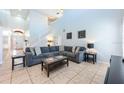 Inviting living room with high ceilings, neutral paint, and tile flooring throughout at 217 Sevilla Ave, Davenport, FL 33897