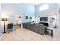 Spacious living room with neutral paint and tile flooring that leads into the bedrooms at 217 Sevilla Ave, Davenport, FL 33897