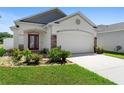 Charming single-story home showcasing a well-manicured lawn and an attached two-car garage at 2285 Canyon Breeze Ave, Kissimmee, FL 34746