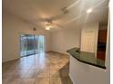 Open concept living room with sliding glass doors and breakfast bar at 2315 Northern Leaf St, Orlando, FL 32817