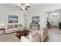 Inviting living room showcasing neutral decor, tile floors, and plenty of natural light at 3492 La Jolla Dr, Clermont, FL 34711