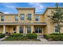 Charming townhome featuring a well-kept exterior, lush bushes, and a nicely manicured landscape at 5481 Limestone Ln # 5481, Lakeland, FL 33809