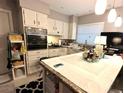 Kitchen with white cabinetry and island countertop at 63 Dahlia Dr, Debary, FL 32713