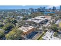 Aerial view of a modern townhome development offering a vibrant urban lifestyle with city skyline in the background at 1004 E Robinson St # 1, Orlando, FL 32801
