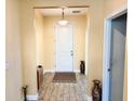Inviting foyer features neutral walls, decorative accents and flooring with decorative area rug at 1337 Ash Tree Cv, Casselberry, FL 32707