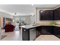 Open-concept kitchen with granite counters, seamlessly connects to the living room, creating an inviting and social atmosphere at 13605 Eridanus Dr, Orlando, FL 32828