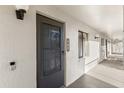Exterior doorway featuring textured walls, with dark metal door and door number at 15 Escondido Ct # 145, Altamonte Springs, FL 32701